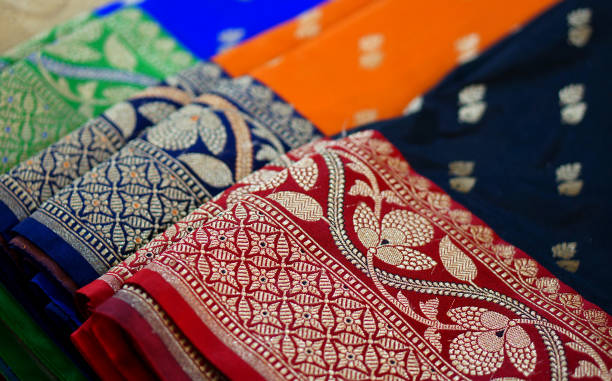 view of Indian woman fashion and tradtional wear sarees in shop display Close-up view of Indian woman fashion and tradtional wear sarees in shop display sari stock pictures, royalty-free photos & images