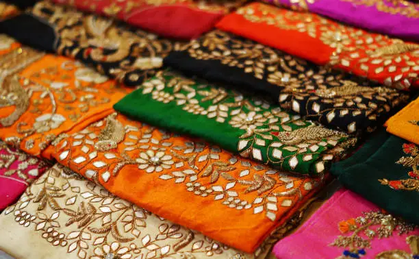 Photo of view of Indian woman wear embroidered salwar kameez in shop display