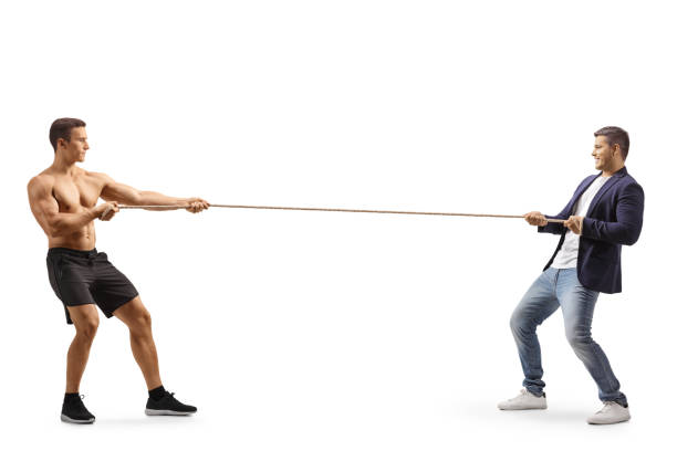 istock Full length profile shot of a man and a bodybuilder pulling a rope 1331735897