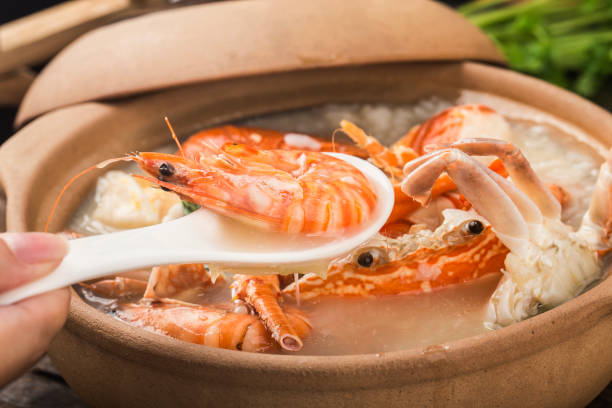 Lobster Seafood congee in casserole Lobster Seafood congee in casserole cantonese cuisine stock pictures, royalty-free photos & images