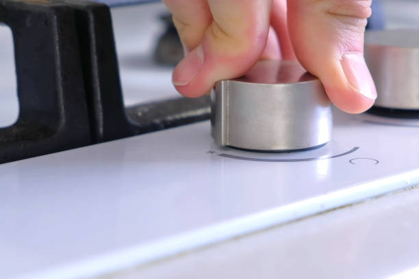 istock Man presses the rotary switch to turn on gas stove. 1331741038