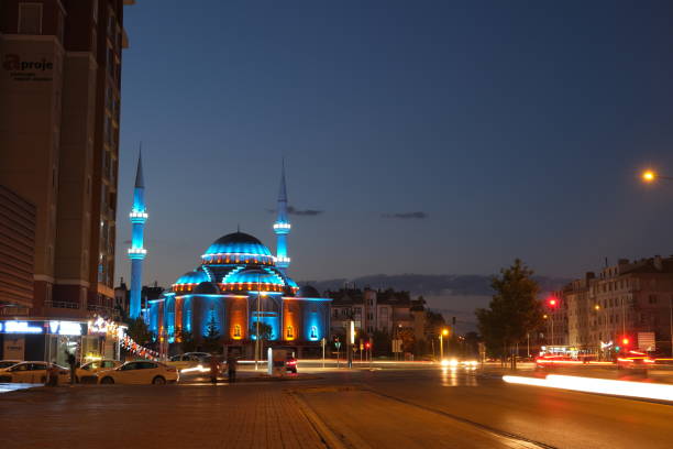 Konya. Turkey. Blue lights on mosque and long exposure photo of cars on city and center of Konya at night