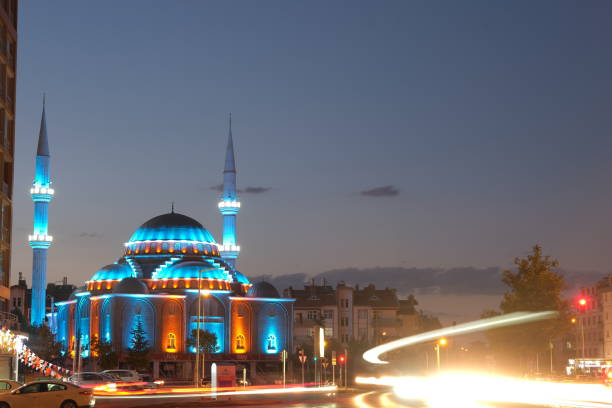 Konya. Turkey. Blue lights on mosque and long exposure photo of cars on city and center of Konya at night