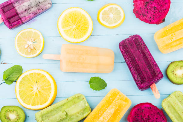 istock Various fruit popsicles are placed on the blue wooden board background, kiwi popsicles, orange popsicles, dragon fruit popsicles, cantaloupe popsicle 1331742041
