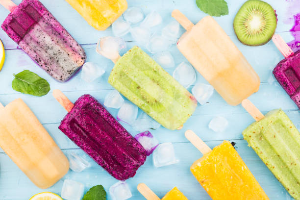 istock Various fruit popsicles are placed on the blue wooden board background, kiwi popsicles, orange popsicles, dragon fruit popsicles, cantaloupe popsicle 1331742099