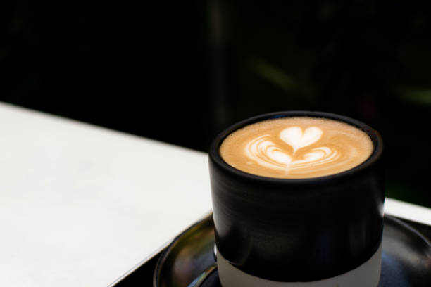 istock Cup of hot coffee with beautiful latte art on table. 1331745329