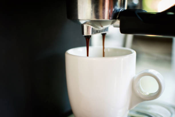 istock Hot coffee dropping into the coffee cup by coffee machine. 1331745358