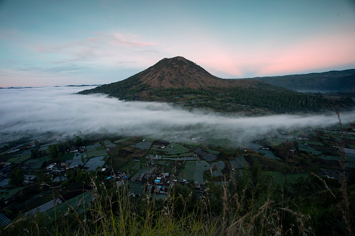 Misty mornings cover the valleys and villages around Mount Batur Kintamani, Bali, Indonesia