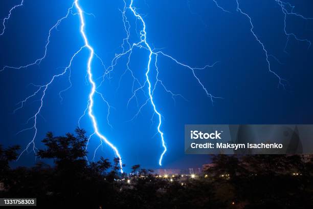 Lightning Discharges During A Large Rainstorm In A City With Forest Fringes Stock Photo - Download Image Now