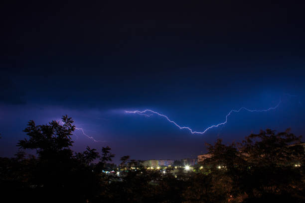 istock Lightning discharges during a large rainstorm in a city with forest fringes 1331758314