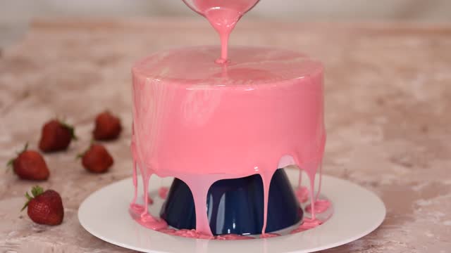 Pastry chef prepares modern french mousse dessert with mirror glaze.