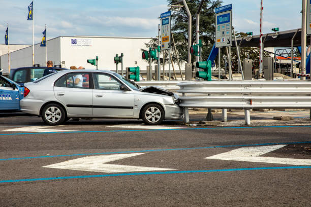 Side View Of Car Wrecked On Road Guardrail At Toll Booth