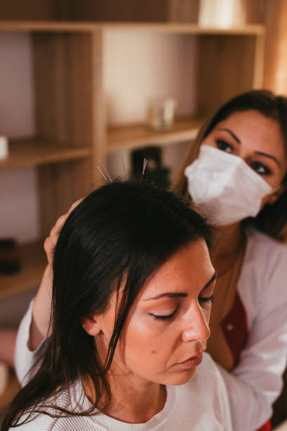 istock Woman having an acupuncture treatment on her head 1331764254