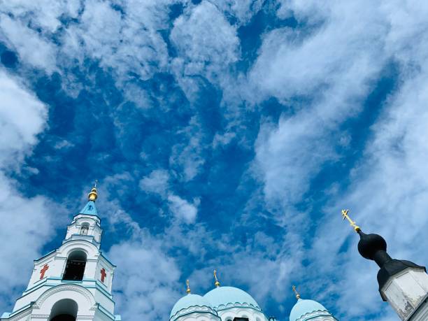 The golden domes of a Christian orthodox churches on blue sky and white snow. Historical complex of orthodox churches in Dmitrov, Moscow region.
