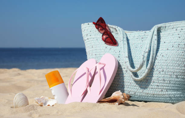 istock Bag and beach accessories on sand near sea 1331765265