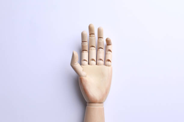 istock Wooden mannequin hand on white background, top view 1331765284