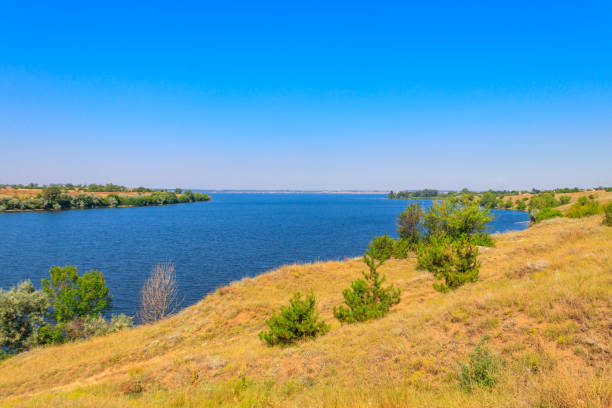 istock Summer landscape with beautiful river, green trees and blue sky 1331765973