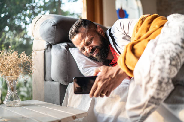 istock Man waking up and checking smartphone at home 1331766121