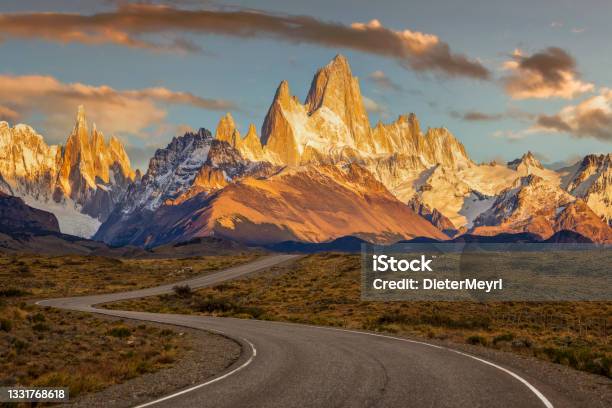A Windy Road Leads To Mt Fitz Roy Surrounding Mountains And The Town Of El Chalten Argentina Stock Photo - Download Image Now