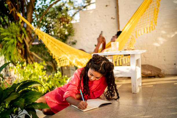 istock Girl studying or writing on a note pad witting on the floor at home 1331772581