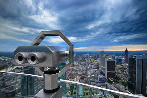 Tourist binoculars. A viewing platform for tourists. Stationary viewing binoculars. Binocular telescope on the observation deck for tourism. Mountain background.