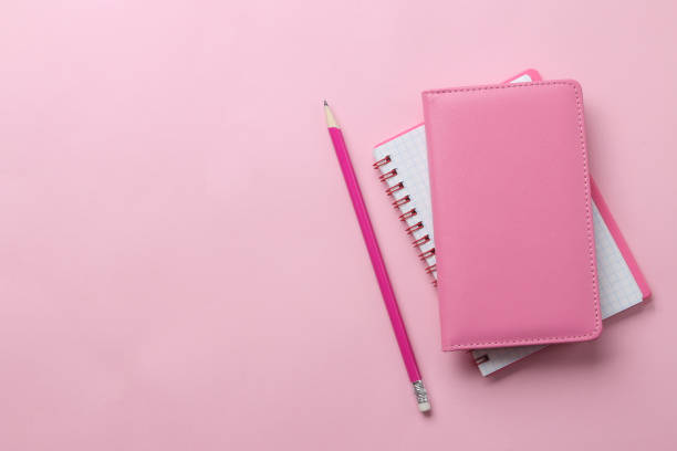 istock several notebooks and a pink pencil on a bright pink background. top view. office tools 1331775551