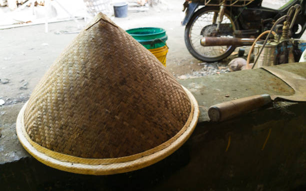 istock farmer hat and sickle laying down on brick shelf 1331776454