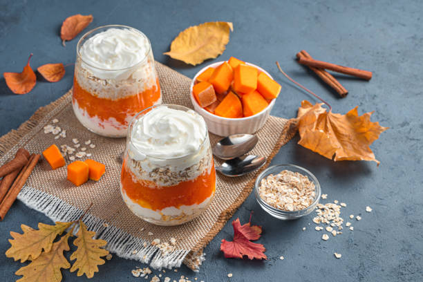 istock Creamy parfait with pumpkin and cereals on a dark blue background. Side view, space for copying 1331777751