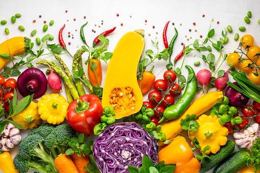 Fresh assorted vegetables and herbs on white background. Healthy clean eating, vegetarian or diet food concept.Food frame. Top view, copy space.