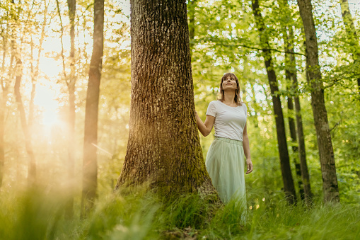 Beautiful woman admiring nature in forest