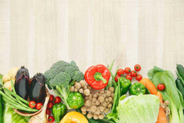 Wood grain background and lots of fresh vegetables stock photo