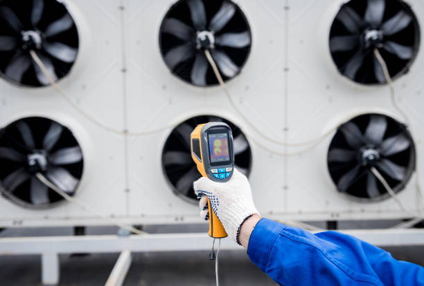 istock Technician uses a thermal imaging infrared thermometer to check the condensing unit heat exchanger. 1331779332
