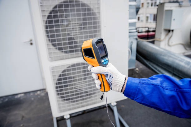 istock Technician uses a thermal imaging infrared thermometer to check the condensing unit heat exchanger. 1331781197