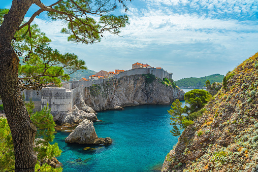 View Dubrovnik old town with city walls, fort Bokar and blue waters of Adriatic sea. Famous european travel destination in Croatia, Europe