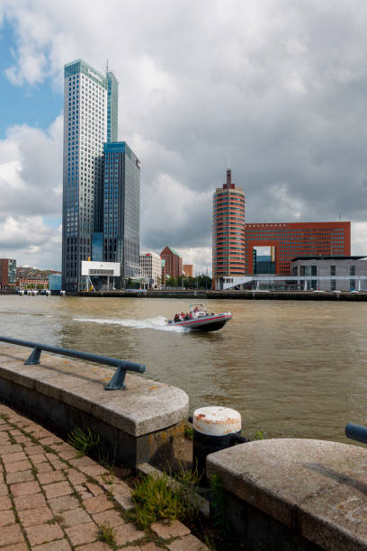 rigid inflatable boat with tourists speeding in the Koningshaven in Rotterdam