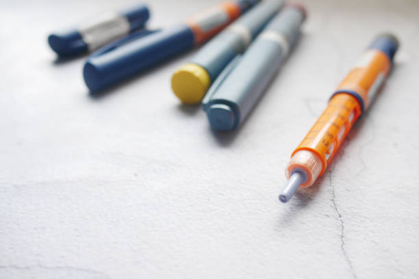 istock Insulin pens on wooden background, close up 1331785194