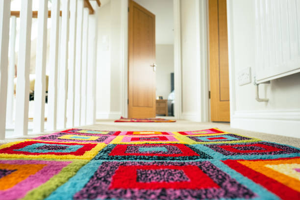 Ground level, shallow focus of a newly installed loft conversion. Ground level, shallow focus of a newly installed loft conversion showing the colour rugs. Leading to a distant bedroom. landing home interior stock pictures, royalty-free photos & images