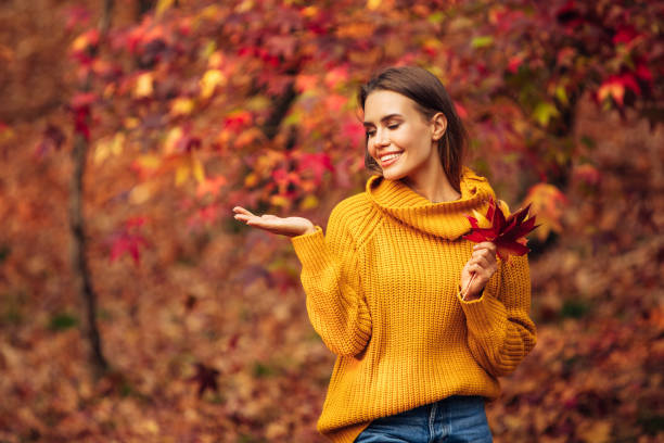 istock Beautiful woman holding a leaf 1331788883