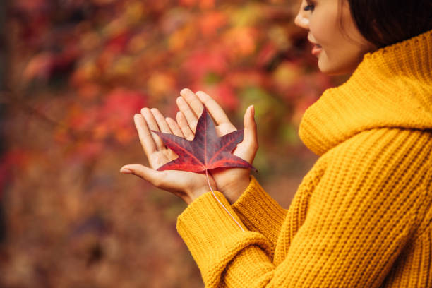 Beautiful woman holding a leaf