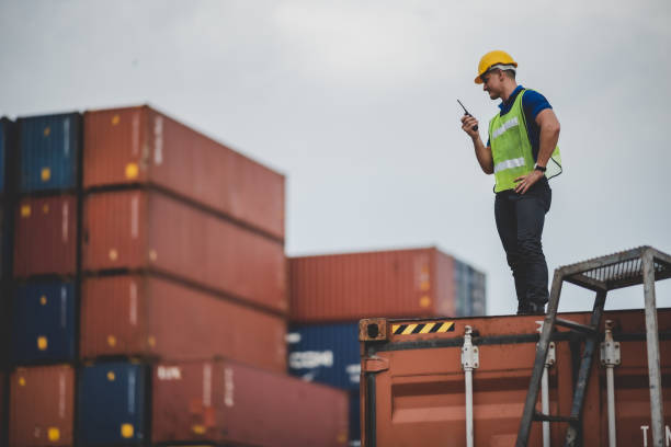 istock engineer foreman working in container cargo logistic shipping industry for import and export transport, freight business at warehouse port terminal, truck loading control at storage 1331790227