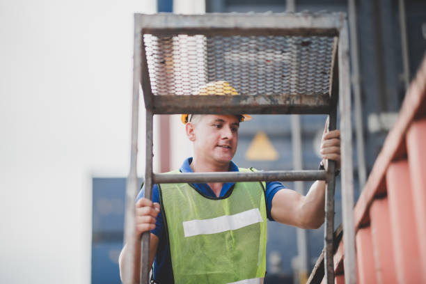 istock engineer foreman working in container cargo logistic shipping industry for import and export transport, freight business at warehouse port terminal, truck loading control at storage 1331790362