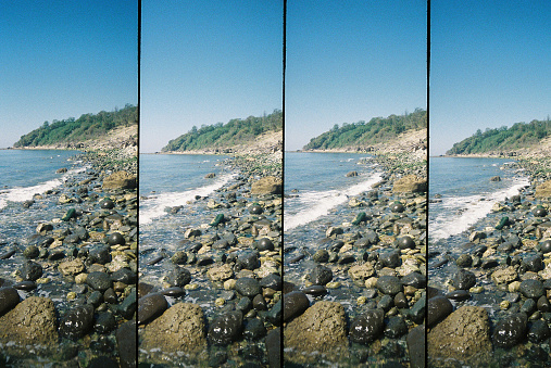 A single wave laps onto a pebbled beach, four 35mm photos of the Jurrassic coastline of Devon.