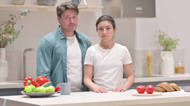 istock Mixed Race Couple Showing No Sign in Kitchen, Head shake 1331795392