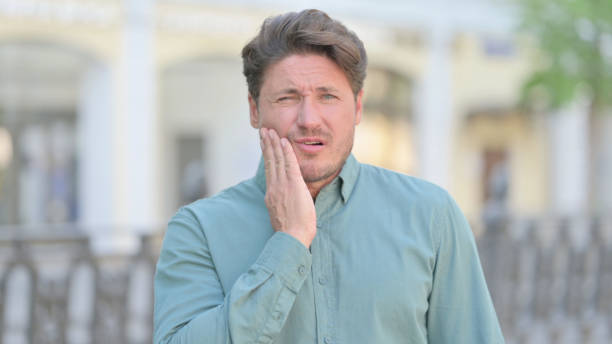 istock Outdoor Middle Aged Man having Toothache, Cavity 1331795534