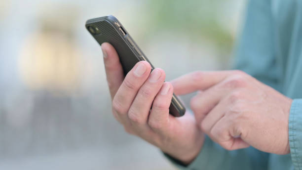 istock Close up of Middle Aged Man Browsing on Smartphone 1331795538
