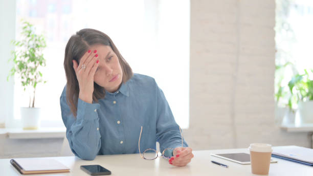 istock Young Woman having Headache in Modern Office 1331795796