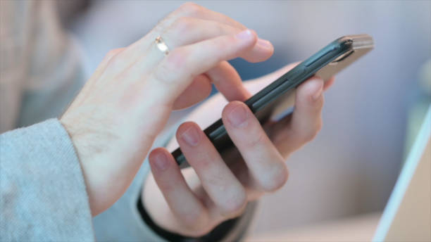 istock Close up of Using Smartphone, Side View 1331796418
