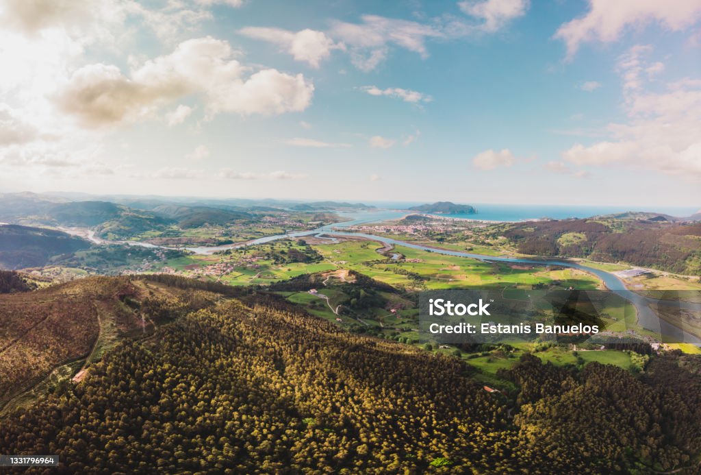360 degree panoramic taken with drone of the bay of the Asón estuary that connects Colindres, Laredo and Santoña through the sea made from the Candiano peak, in Cantabria. Top aerial view. Cantabria Stock Photo