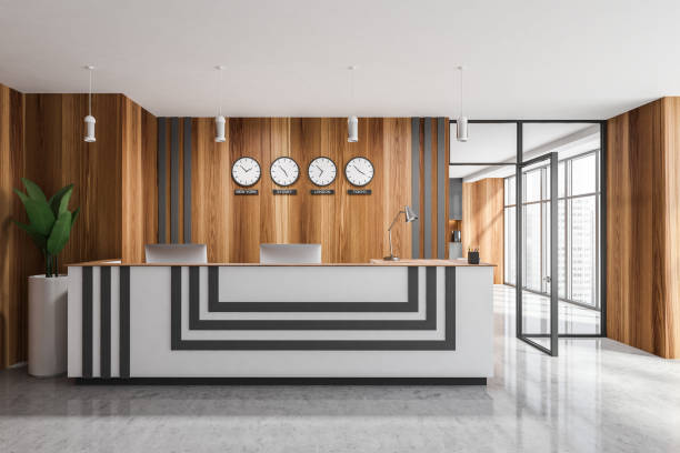 istock Reception desk in wooden office interior with clocks 1331798594