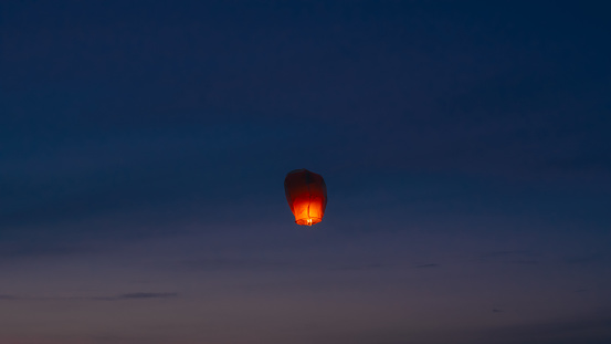 Burning sky lantern floating in air